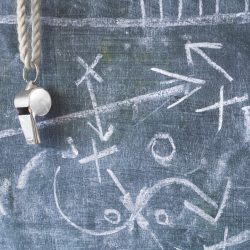 whistle of a soccer or football referee / coach on black board with tactical diagram whistle of a soccer or football referee / coach on black board with tactical diagram
